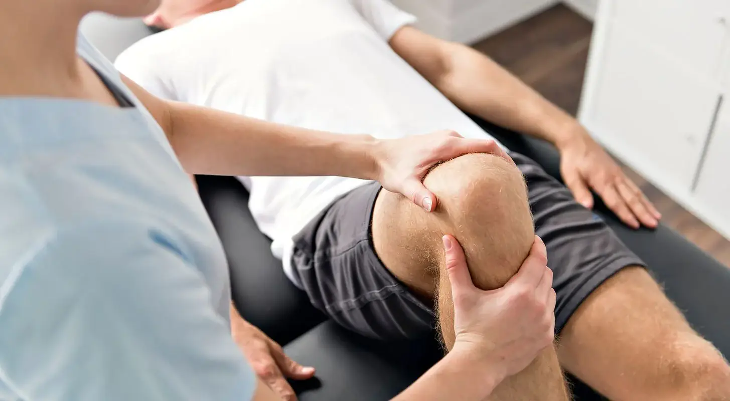 Chiropractor performing a knee adjustment